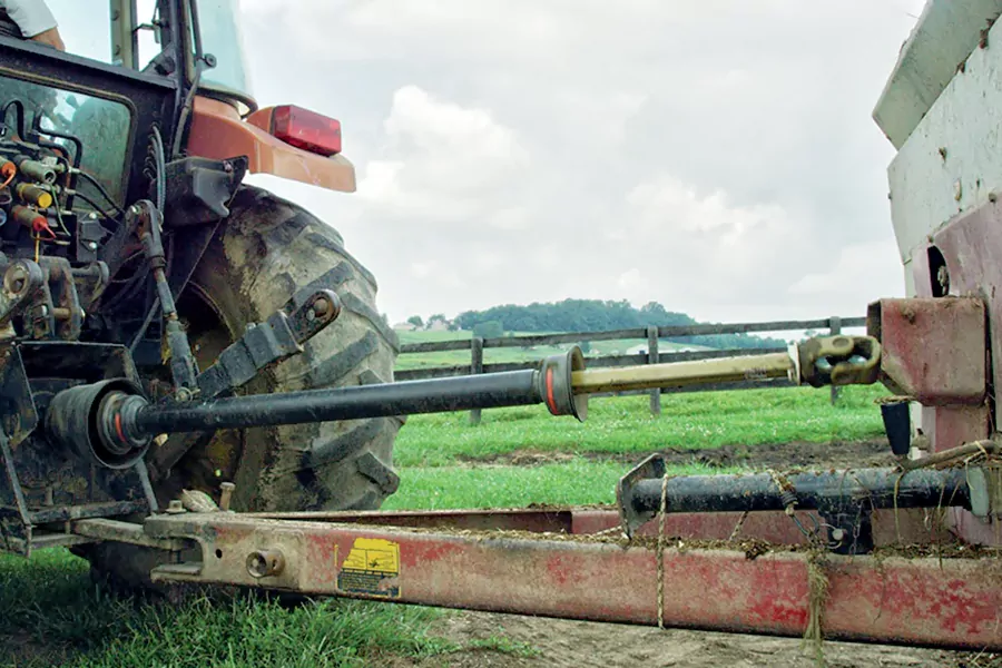 The tractor is connected to the implement using a PTO shaft