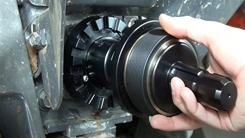 Tractor PTO adapter being installed on the PTO output shaft, showing a quick coupler being aligned with the splined tractor PTO connection.