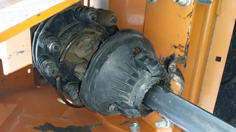 Damaged PTO shaft guard with cracked safety shield