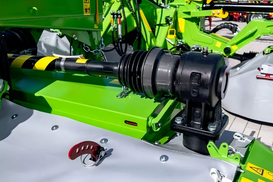 The picture shows a PTO shaft with a guard installed on an agricultural machinery.