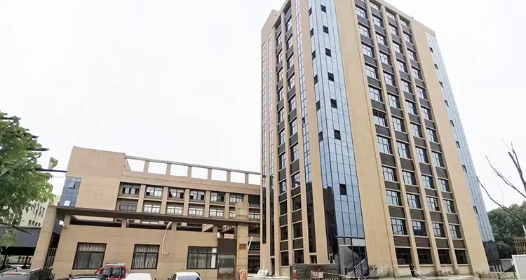This picture shows the external perspective of the Baiquan factory, revealing a large workshop, a building, and a security guard room